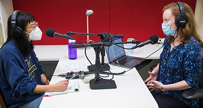Meg Riker talking into a microphone
